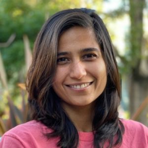 PIcture of Gauri Manglik, woman with dark, mid-length hair in front of blurred trees in back ground.