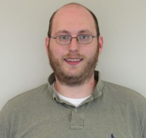 Head and shoulders picture of Jon Bergdoll, white mail with glasses and beard.
